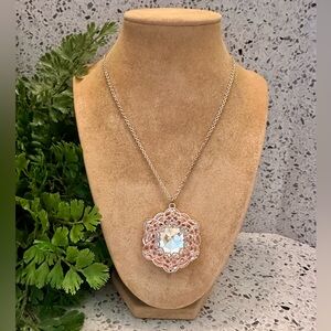 Copper tone filigree pendant with crystal center